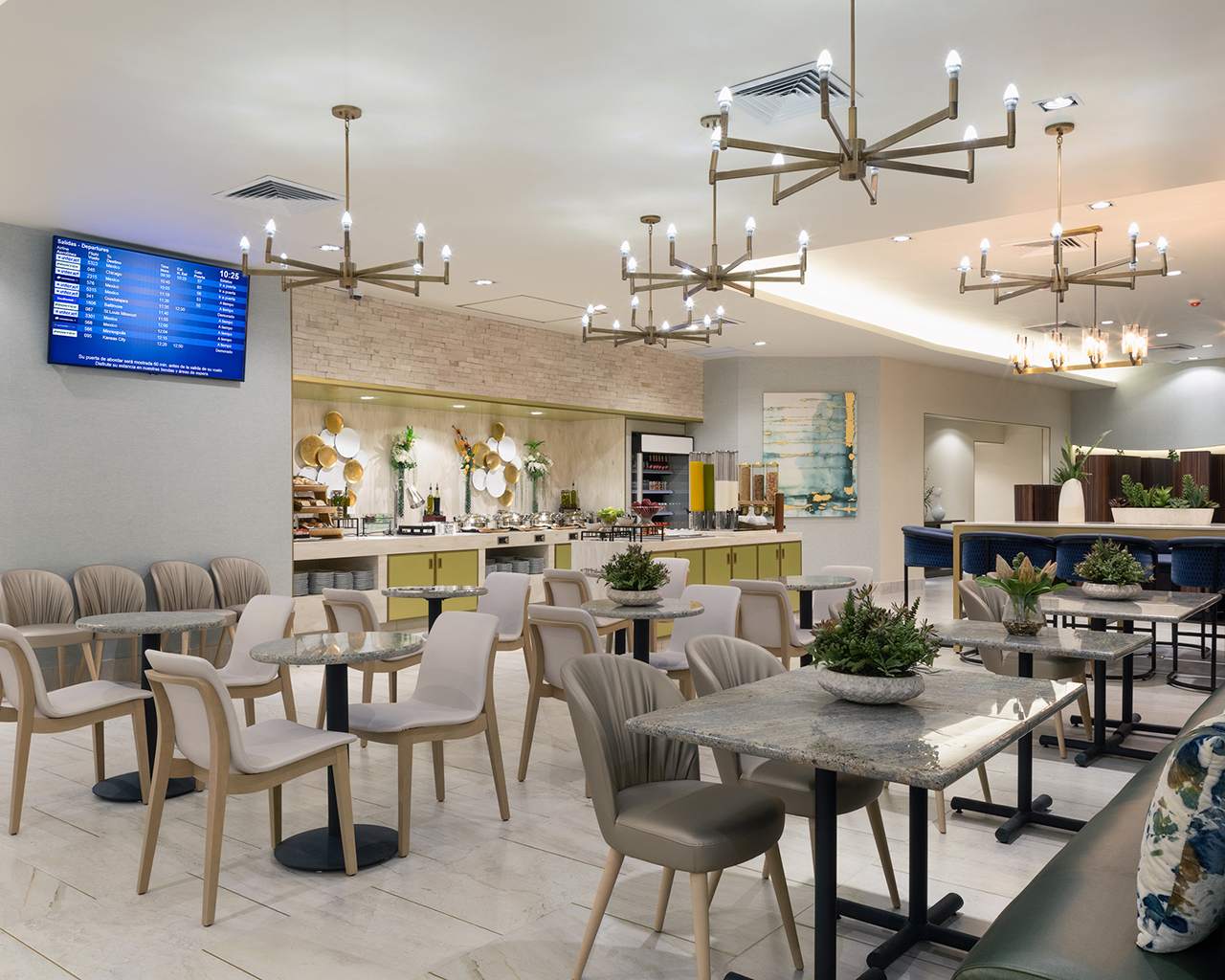 A dining area in the Mera Business Lounge Domestic Cancun with marble-top tables, upholstered chairs, and small plant centerpieces. A dining area in the Mera Business Lounge Domestic Cancun with marble-top tables, upholstered chairs, and small plant centerpieces.