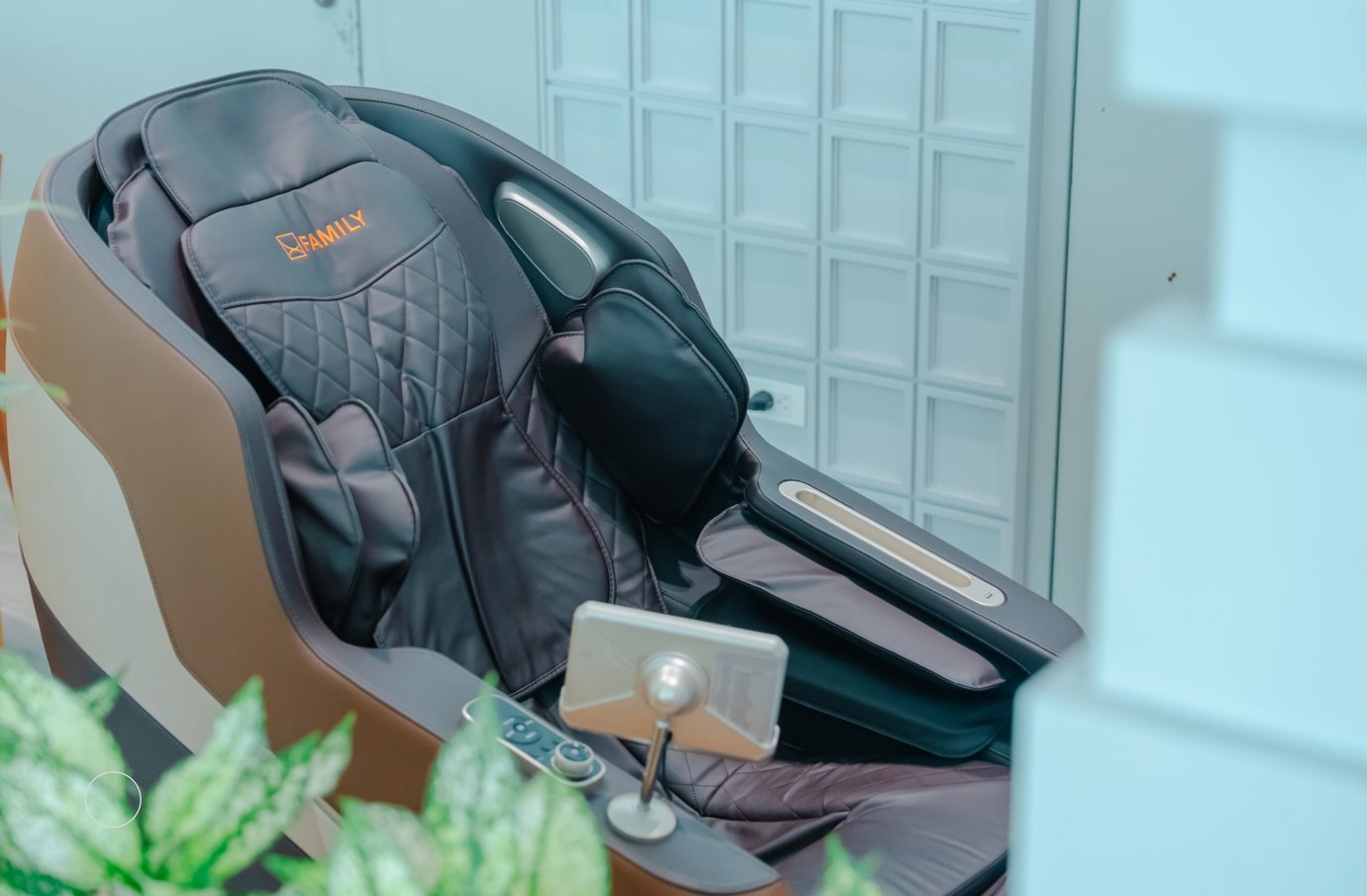 Black leather massage chair with quilted padding and built-in controls at the SH Premium Lounge at Cat Bi Airport.