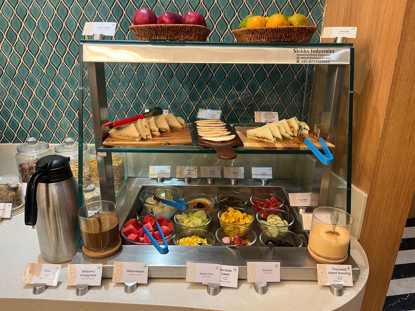 Cold buffet station at the Good Times Bar Lounge, Mumbai Airport T1, featuring sandwiches, fresh fruit, salads, condiments, and beverages Cold buffet station at the Good Times Bar Lounge, Mumbai Airport T1, featuring sandwiches, fresh fruit, salads, condiments, and beverages