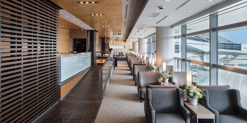 The Plaza Premium Lounge at Chubu Centrair International Airport features comfortable seating with views of the airport tarmac through large windows.