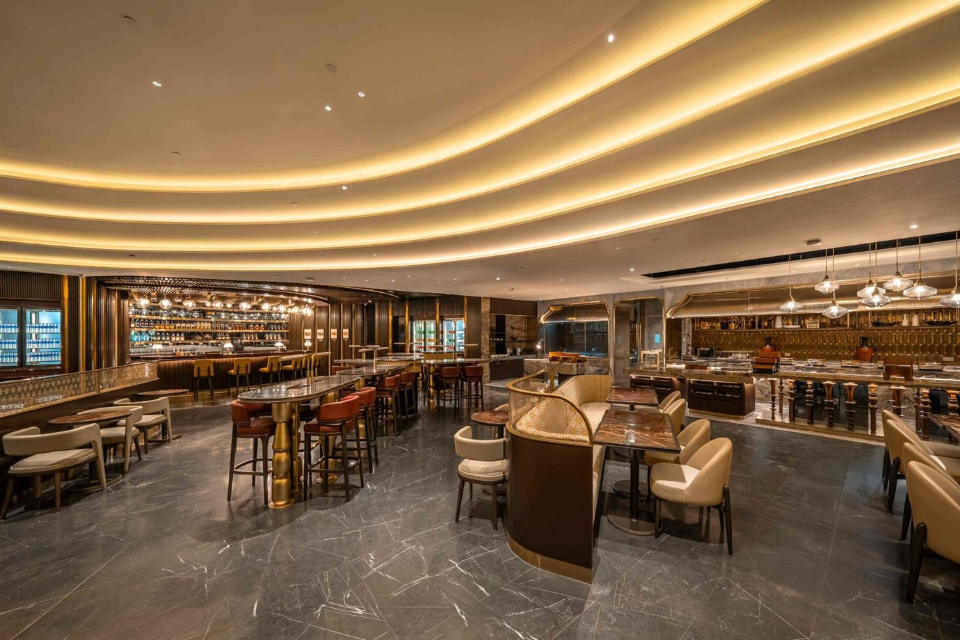 Air India Maharaja Lounge Business Class area at Delhi Airport (DEL), featuring elegant bar seating, marble flooring, ambient ceiling lighting, and premium dining spaces.
