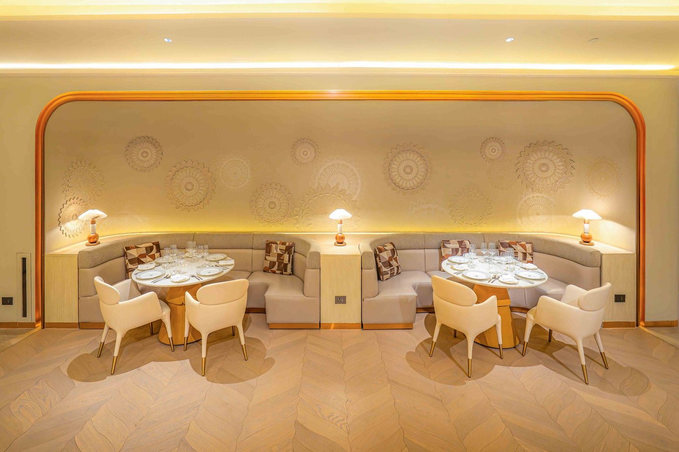 Air India Maharaja Lounge First Class dining section at Delhi Airport (DEL), showcasing private booth seating, warm golden lighting, and refined fine-dining setup for premium passengers.
