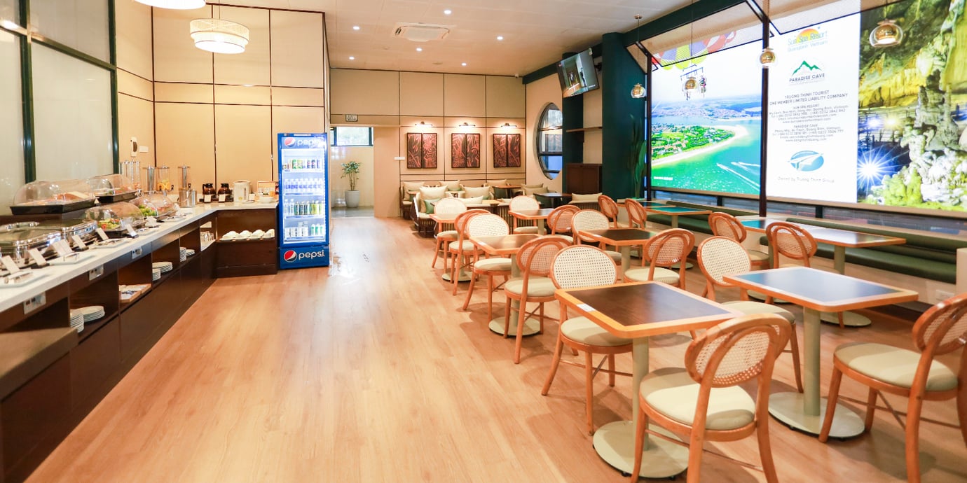 Dining and seating area at SH Premium Lounge, Dong Hoi Airport (VDH), featuring buffet service, and comfortable tables and chairs. Dining and seating area at SH Premium Lounge, Dong Hoi Airport (VDH), featuring buffet service, and comfortable tables and chairs.