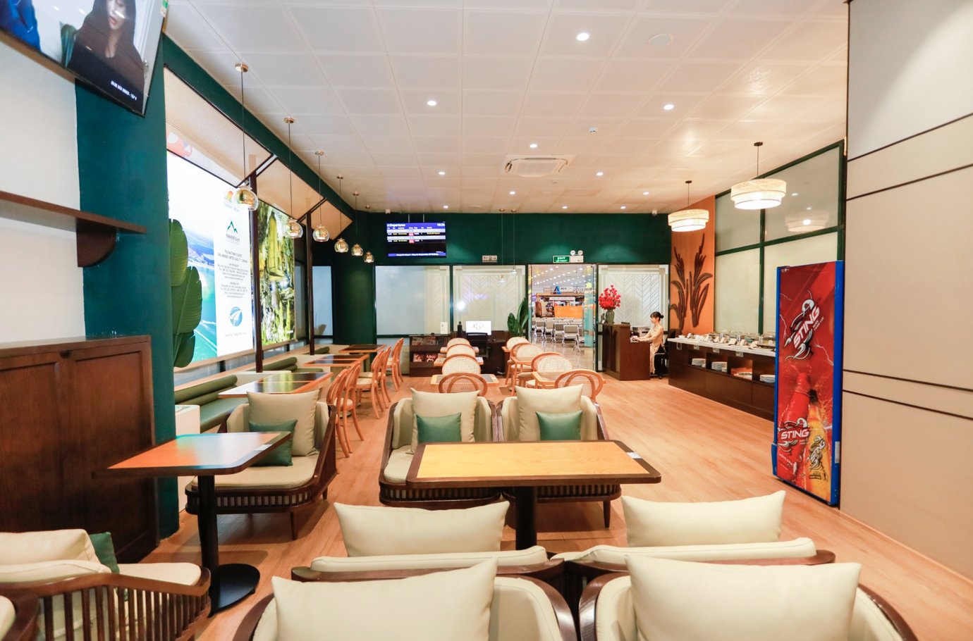 Seating area inside SH Premium Lounge at Dong Hoi Airport (VDH), featuring comfortable armchairs, dining tables, buffet counter, and a relaxed airport lounge environment for departing passengers. Seating area inside SH Premium Lounge at Dong Hoi Airport (VDH), featuring comfortable armchairs, dining tables, buffet counter, and a relaxed airport lounge environment for departing passengers.