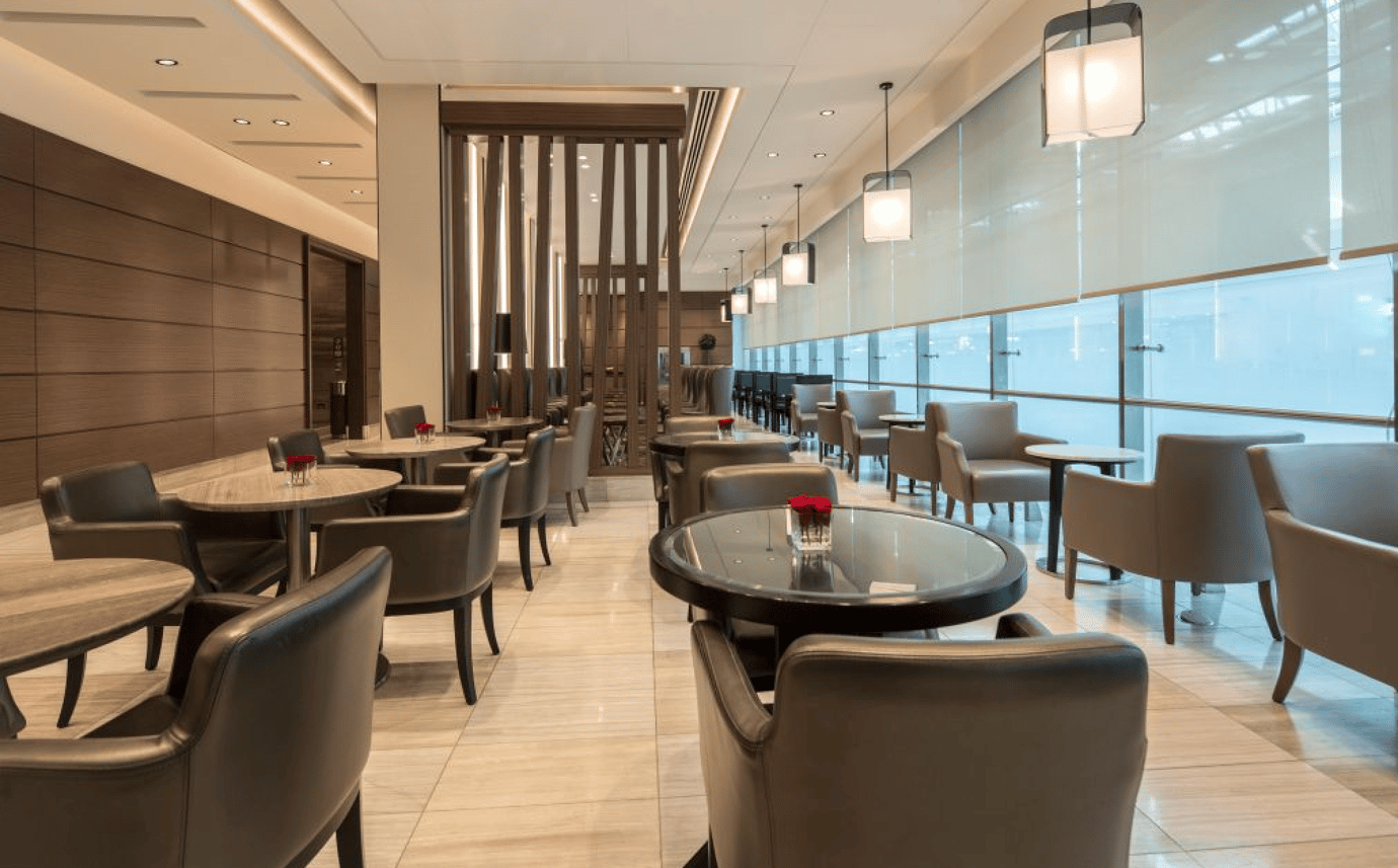 Spacious dining area inside the Ahlan Business Class Lounge at Dubai International Airport Terminal 1, featuring elegant seating, soft lighting, and large windows that create a calm, upscale atmosphere for travellers. Spacious dining area inside the Ahlan Business Class Lounge at Dubai International Airport Terminal 1, featuring elegant seating, soft lighting, and large windows that create a calm, upscale atmosphere for travellers.