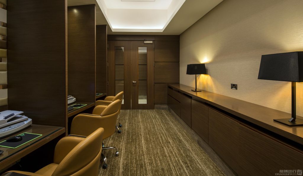 Private business center inside the Ahlan First Class Lounge at Dubai International Airport Terminal 1, featuring leather chairs, computer workstations, and elegant wooden décor designed for productivity and comfort. Private business center inside the Ahlan First Class Lounge at Dubai International Airport Terminal 1, featuring leather chairs, computer workstations, and elegant wooden décor designed for productivity and comfort.