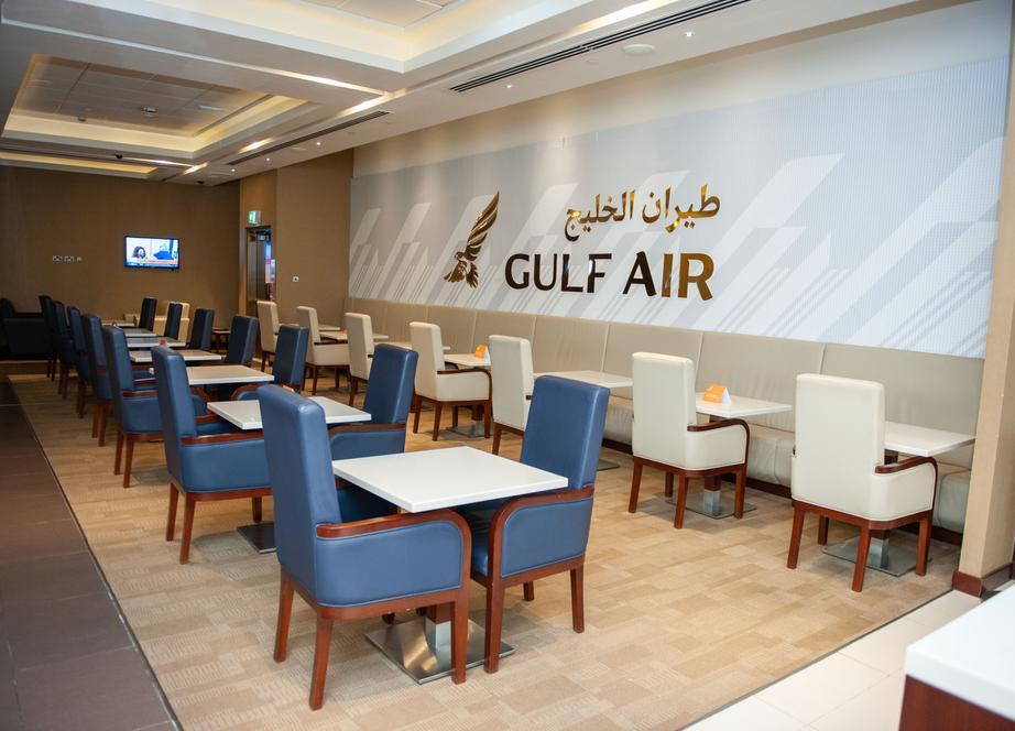 Dining area inside the Gulf Air Falcon Gold Lounge at Dubai International Airport Terminal 1, featuring neatly arranged leather chairs, modern tables, and the Gulf Air logo displayed on the wall. Dining area inside the Gulf Air Falcon Gold Lounge at Dubai International Airport Terminal 1, featuring neatly arranged leather chairs, modern tables, and the Gulf Air logo displayed on the wall.