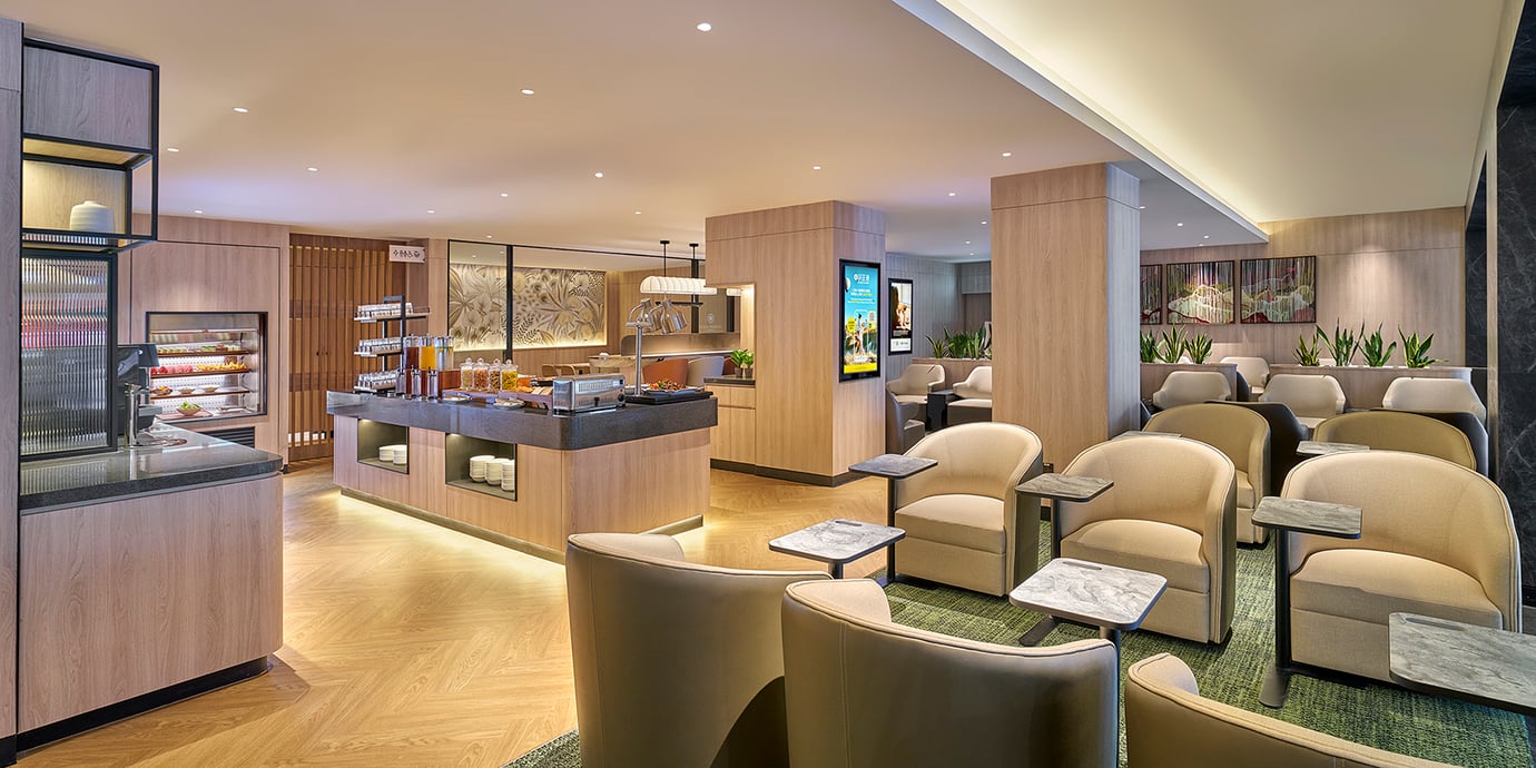 Plaza Premium Lounge at Langkawi Airport with seating area, buffet station, and modern interior design.