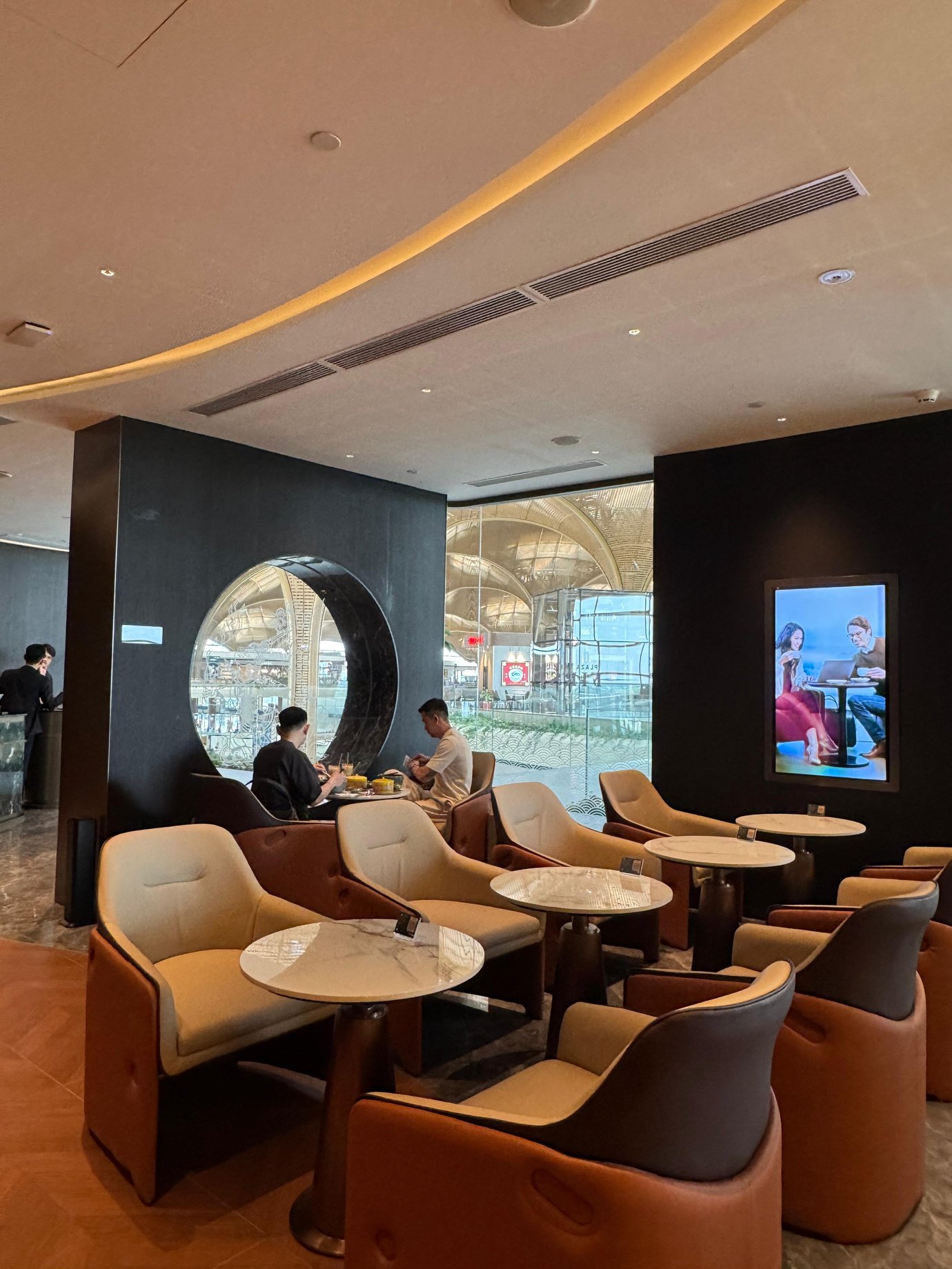 The seating area at Plaza Premium First in Techo International Airport features comfortable chairs and tables for dining and relaxation.