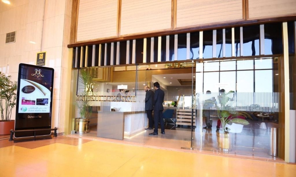 Majestic Lounge entrance at Jinnah International Airport (KHI), featuring glass doors, reception desk, and dedicated lounge staff assisting premium travelers.
