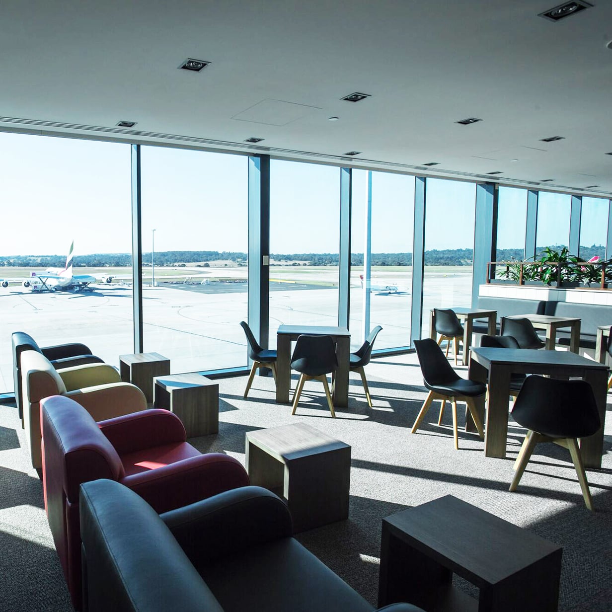 Marhaba lounge at Melbourne Airport with runway views, seating area, and large floor-to-ceiling windows.