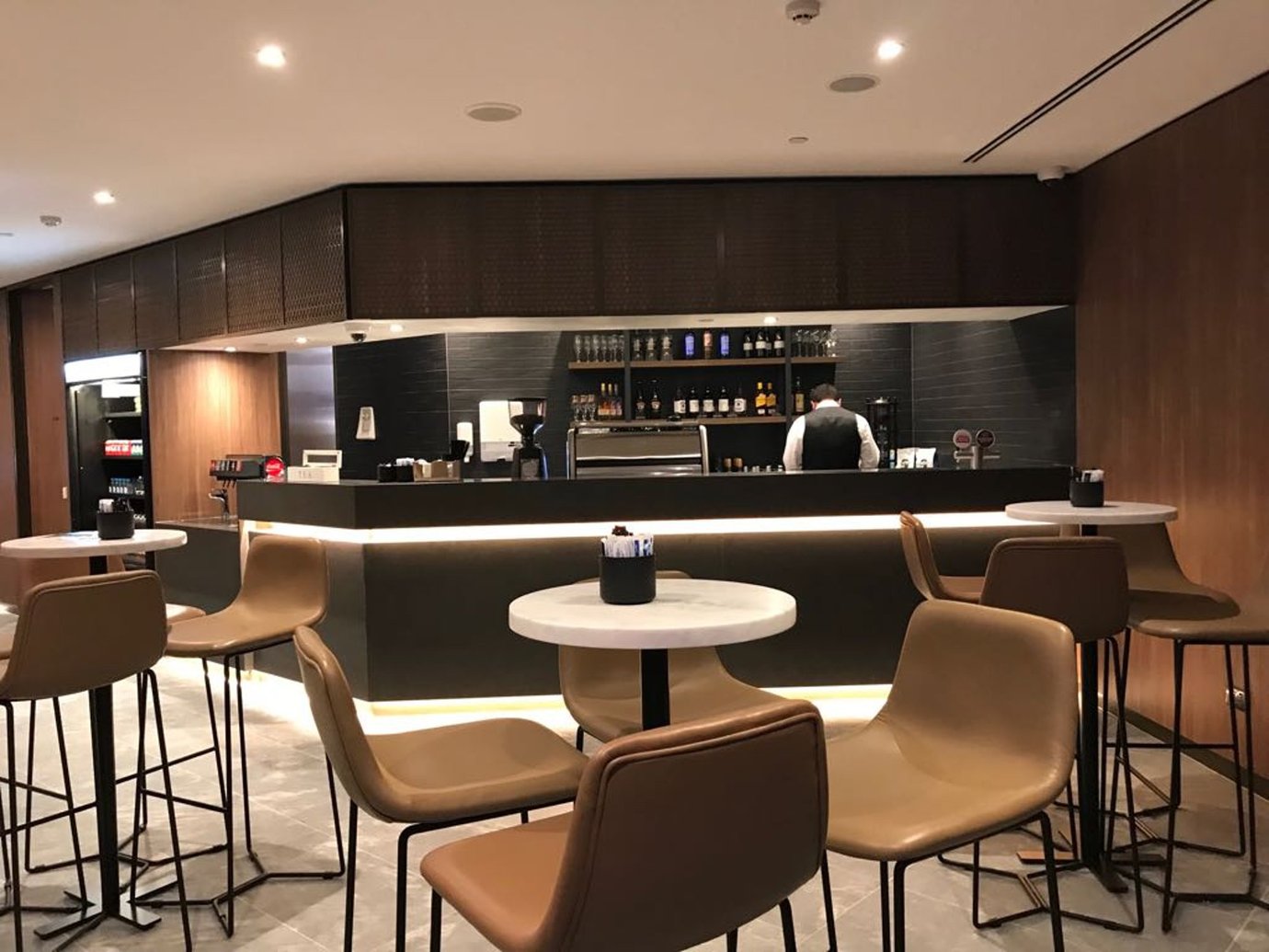 Plaza Premium Lounge Melbourne Airport bar area with drinks counter and modern seating.