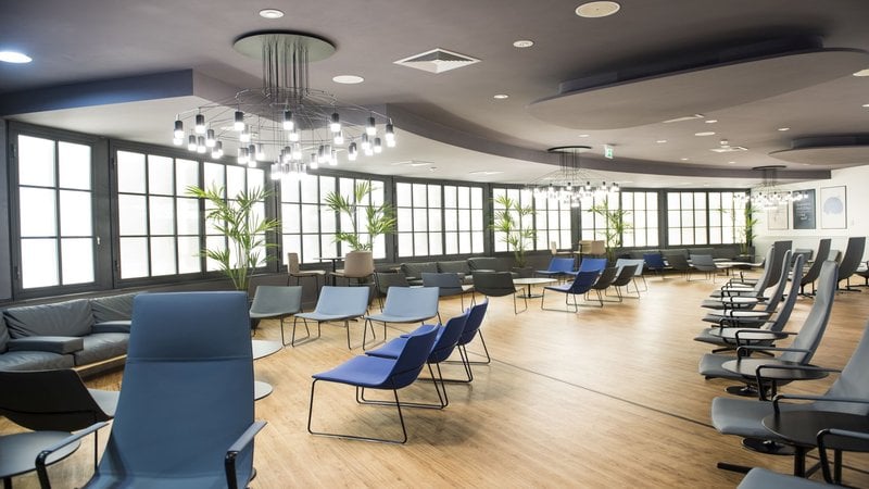 The Prima Vista Lounge at Leonardo da Vinci-Fiumicino Airport features spacious seating with chairs and tables, providing a comfortable waiting area. The Prima Vista Lounge at Leonardo da Vinci-Fiumicino Airport features spacious seating with chairs and tables, providing a comfortable waiting area.