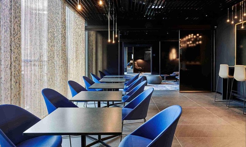 The Prima Vista Lounge at Leonardo da Vinci-Fiumicino Airport features a seating area with tables and chairs for dining or relaxation. The Prima Vista Lounge at Leonardo da Vinci-Fiumicino Airport features a seating area with tables and chairs for dining or relaxation.