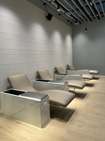 Reclining lounge chairs at Primeclass Lounge in Leonardo da Vinci-Fiumicino Airport offer built-in charging stations for travelers. Reclining lounge chairs at Primeclass Lounge in Leonardo da Vinci-Fiumicino Airport offer built-in charging stations for travelers.