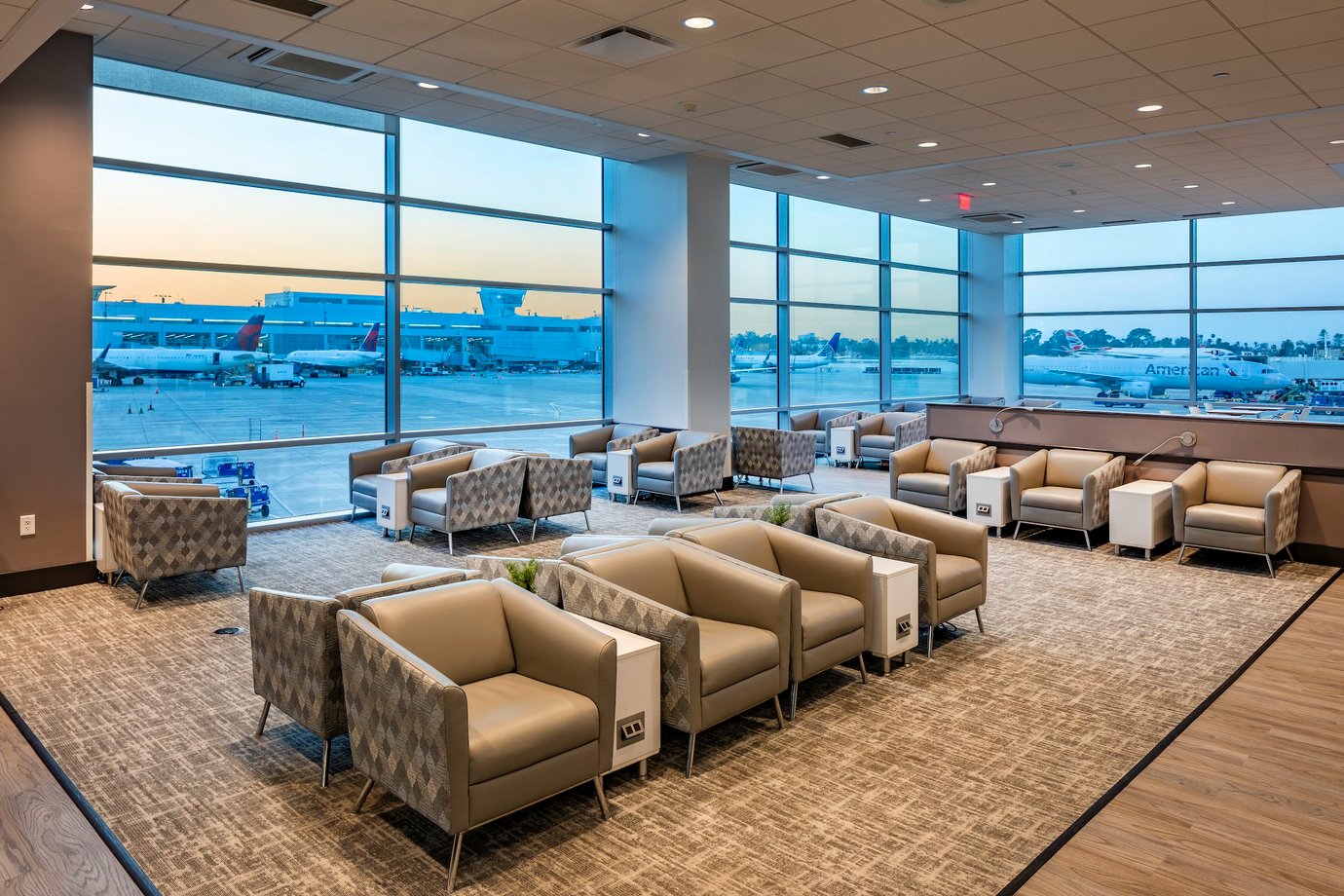 Aspire Lounge San Diego Airport Seating Options with views over runway and tarmac at sunset