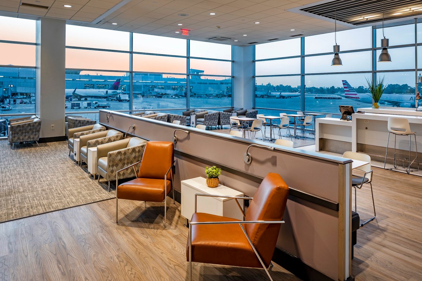 Aspire Lounge San Diego Airport Seating Options with views over runway and tarmac at sunset